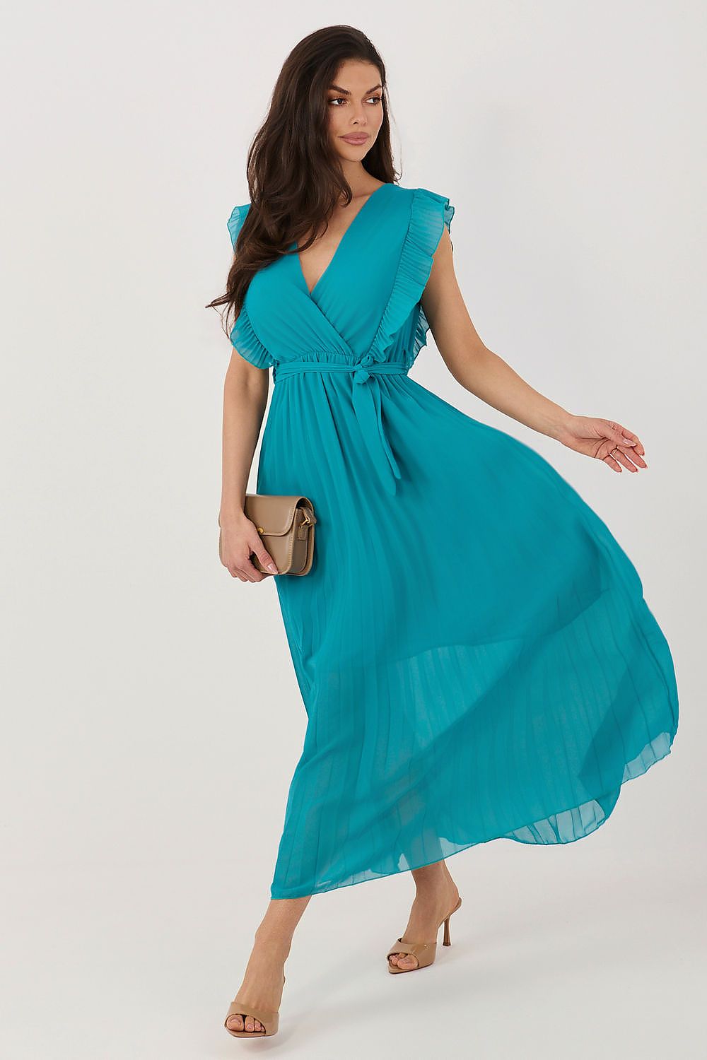 Woman wearing a teal dress on a white background