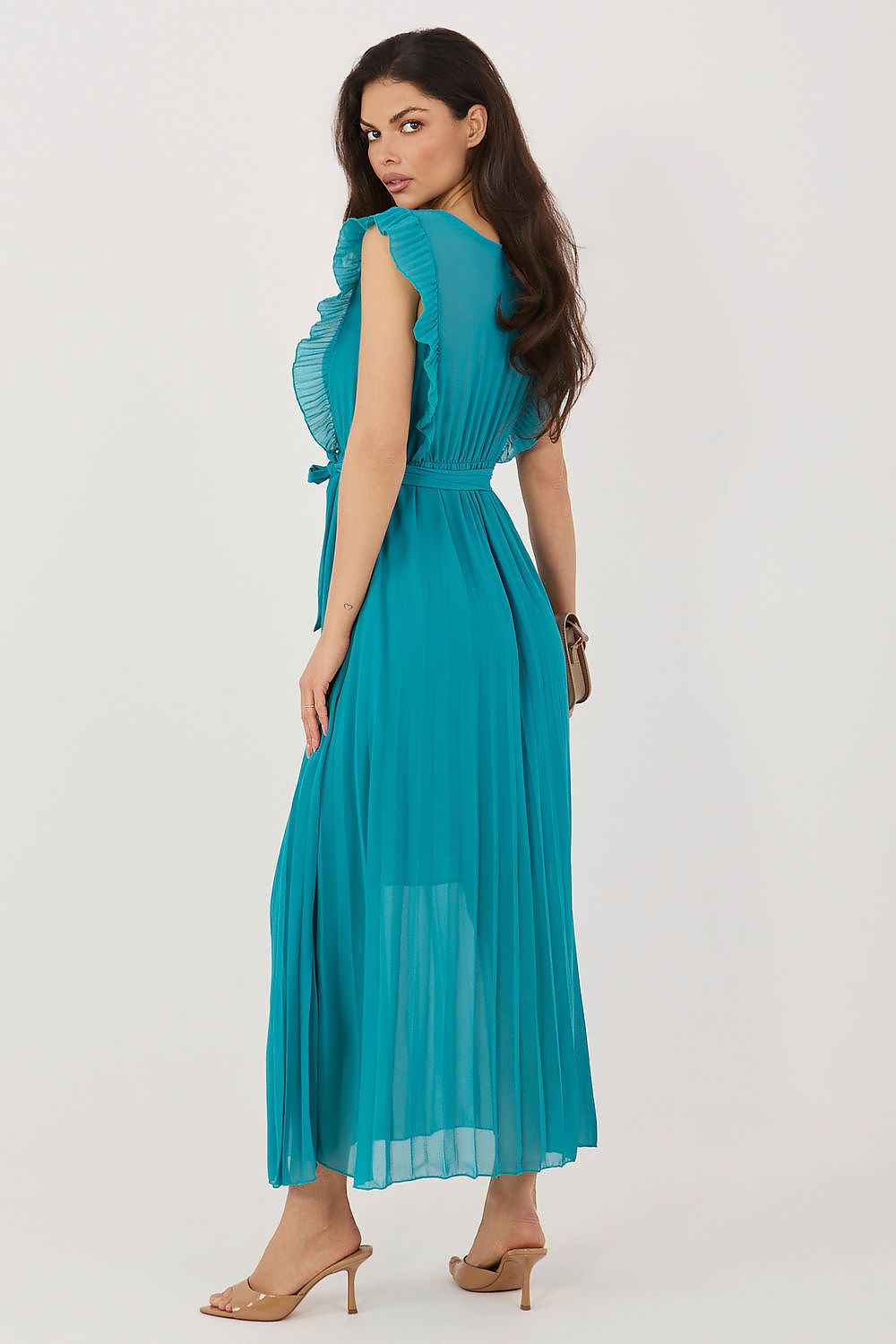 Woman wearing a teal dress on a white background