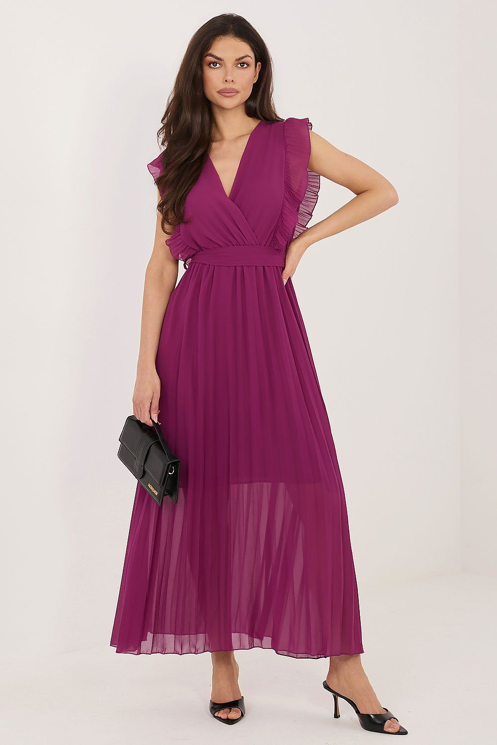 Woman wearing a purple dress with ruffled sleeves on a white background