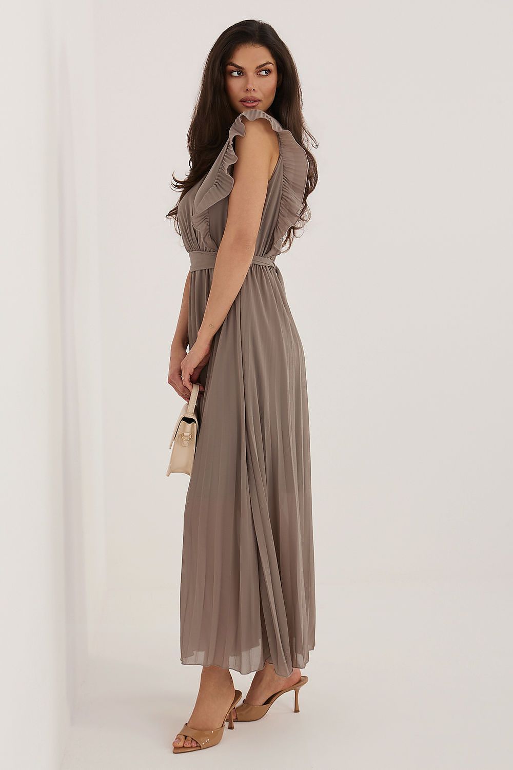 Woman wearing a brown dress against a white background