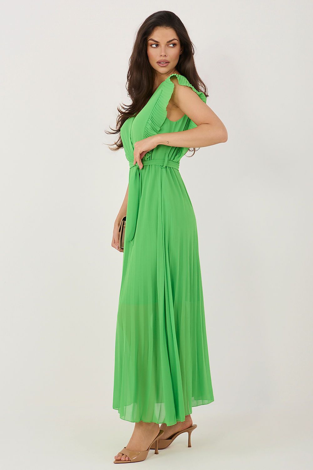 Woman wearing a green dress against a white background