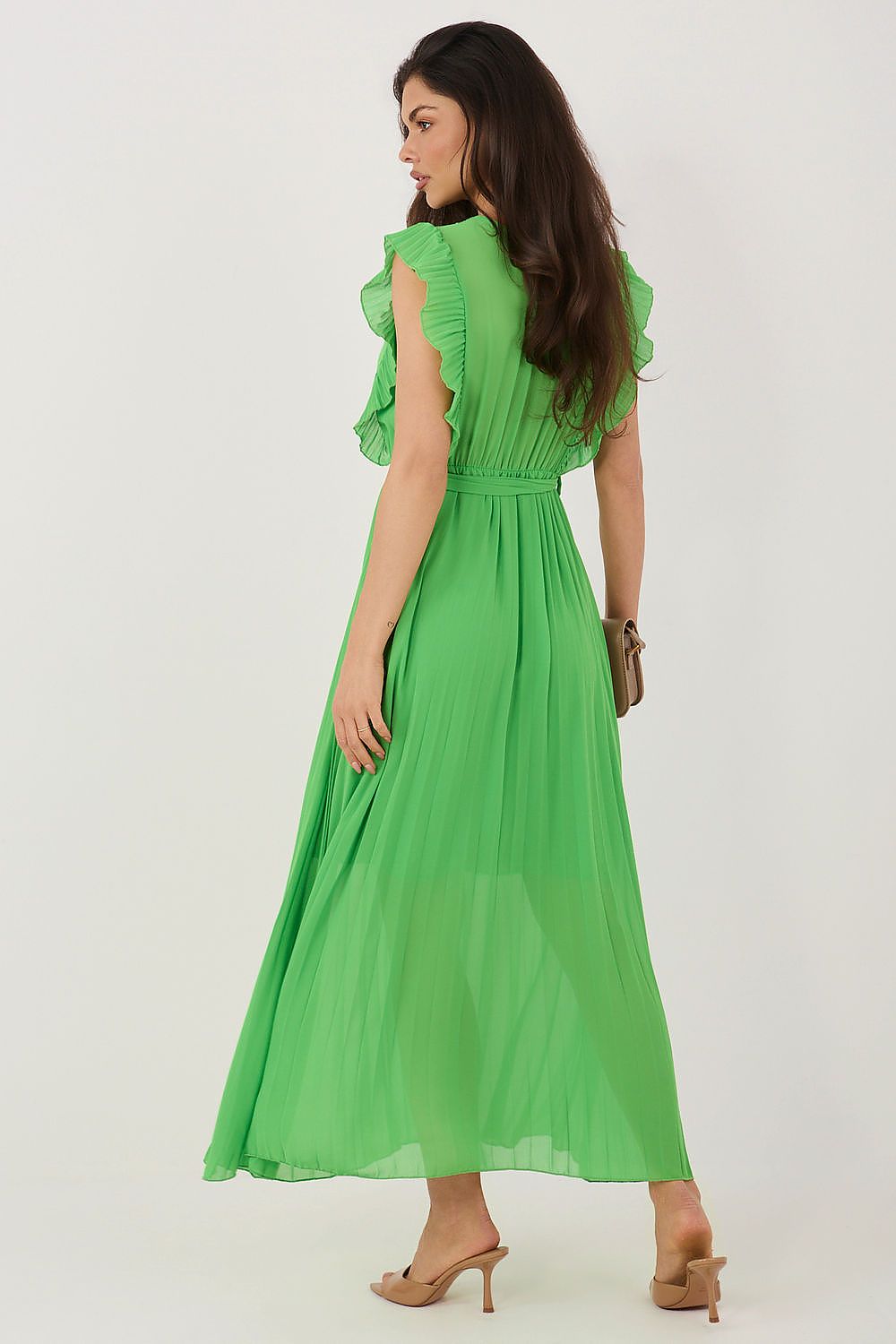 Woman wearing a green dress on a white background
