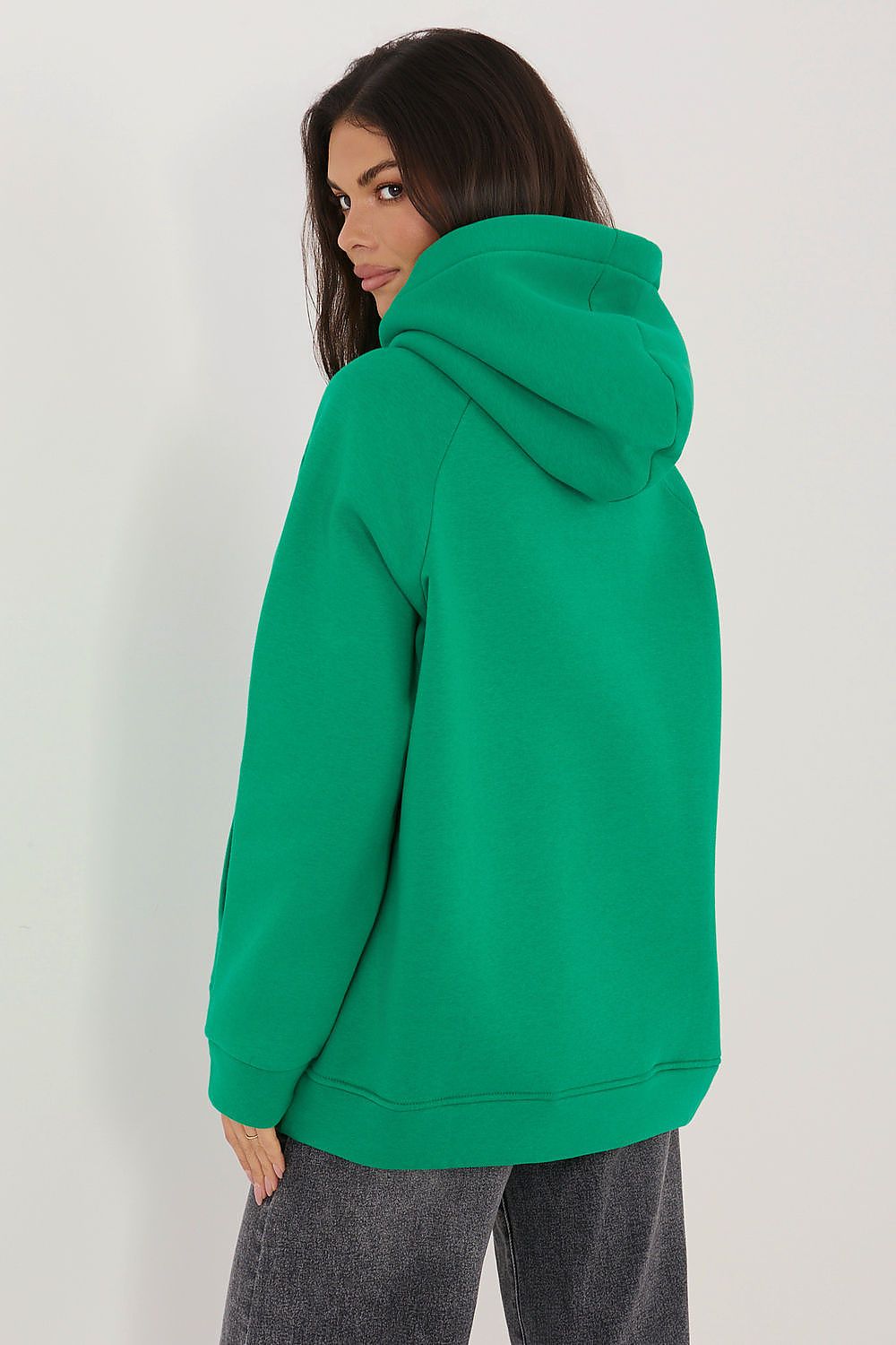 Person wearing a green hoodie from behind on a white background