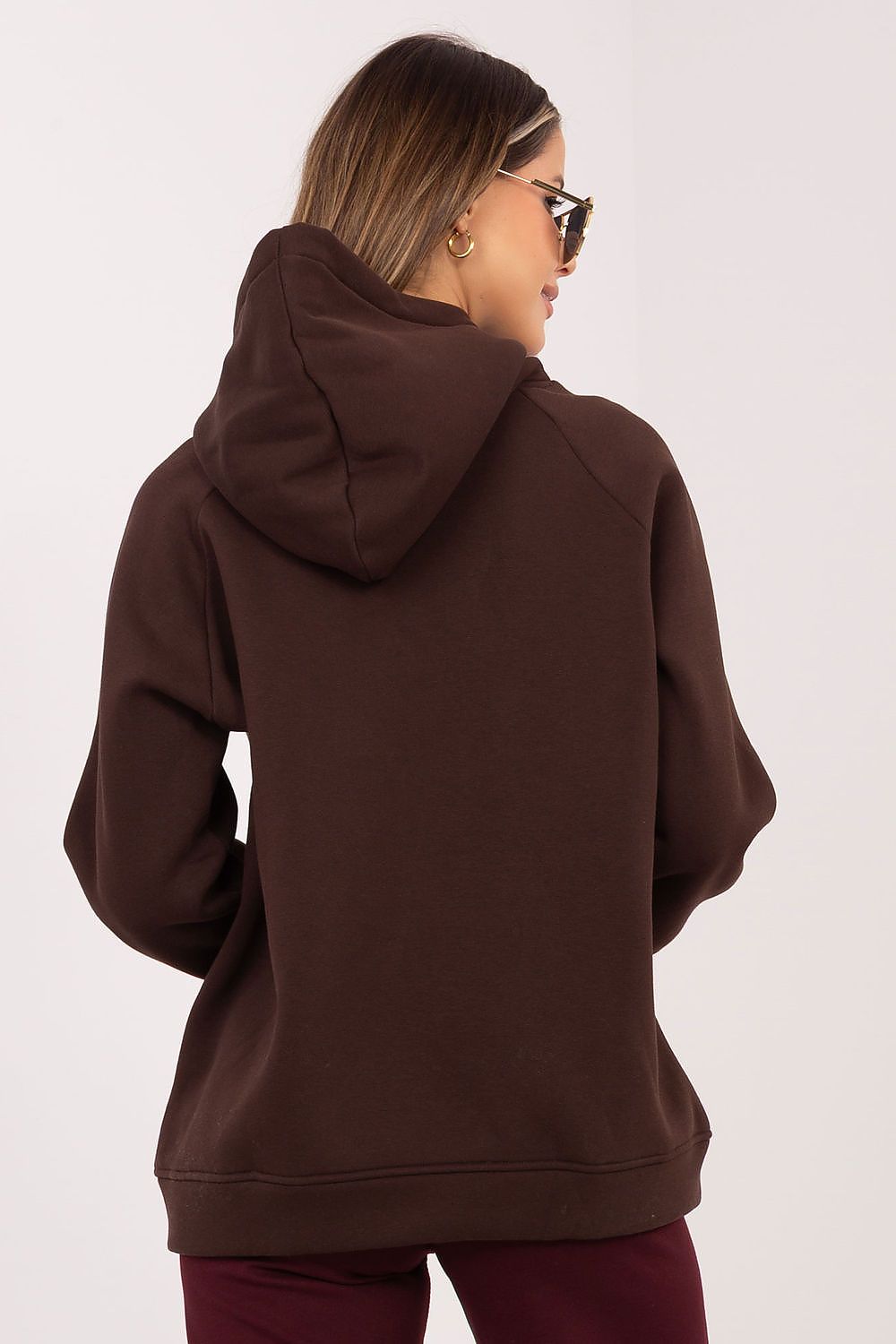 Person wearing a brown hoodie from behind on a white background