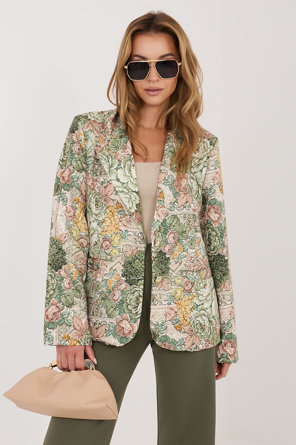Woman wearing a floral patterned jacket on a white background