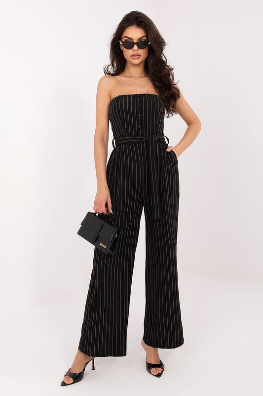 Woman wearing a black pinstripe jumpsuit on a white background