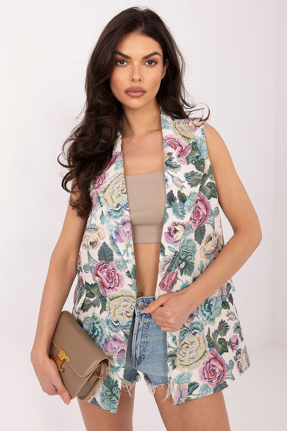 Woman wearing a floral sleeveless top with a plain background