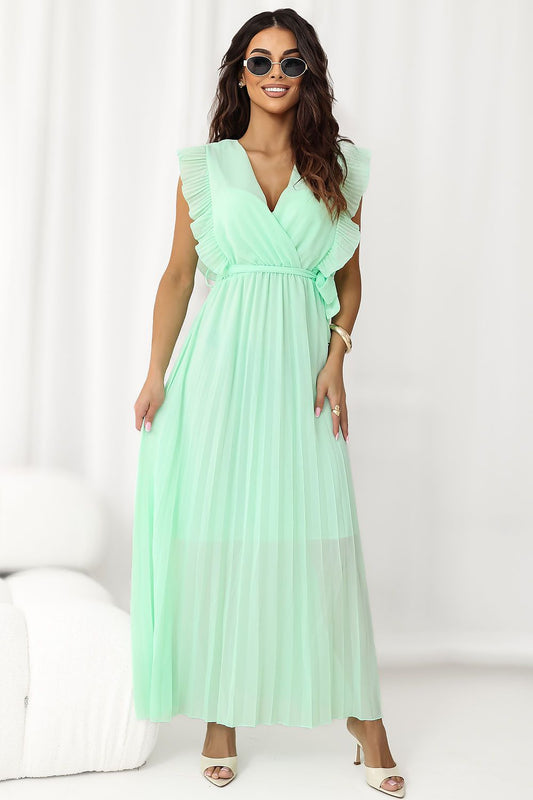 Woman wearing a light green dress against a white background