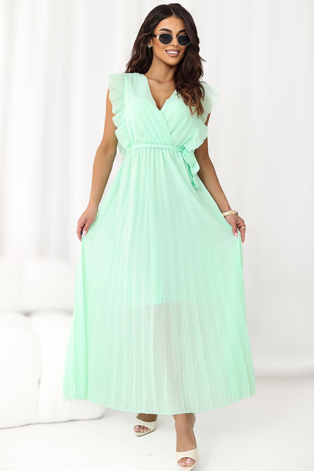Woman wearing a light green dress on a white background