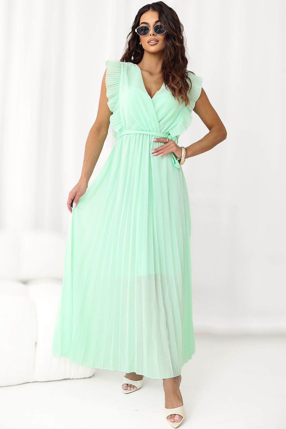 Woman wearing a light green dress on a white background