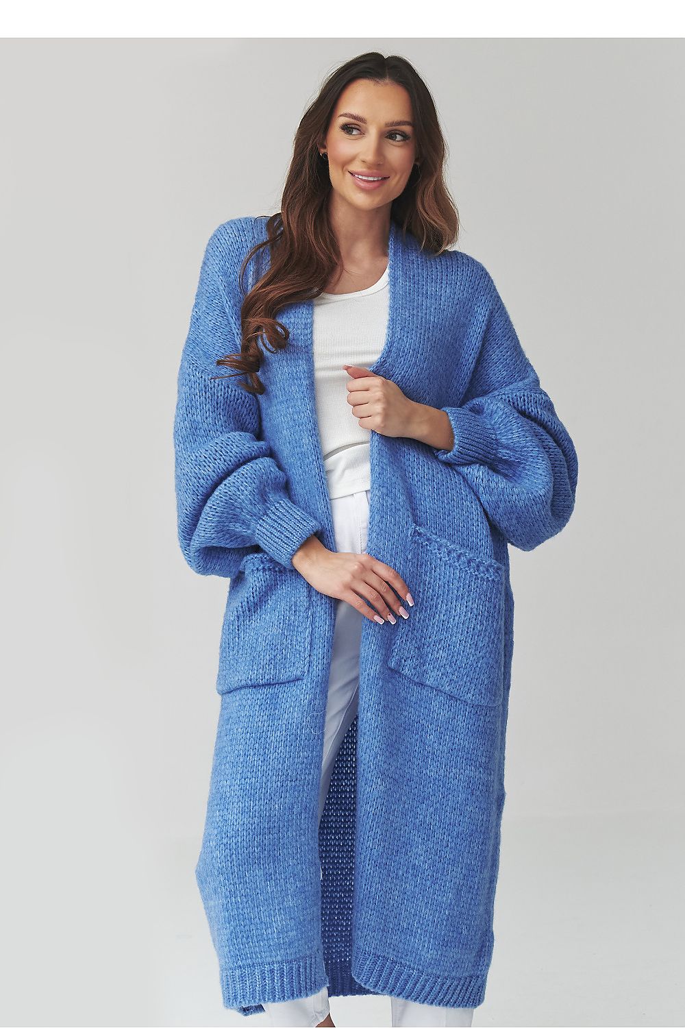 Woman wearing a blue cardigan on a gray background