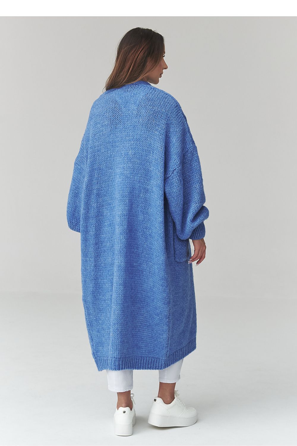 Woman wearing a blue cardigan on a white background