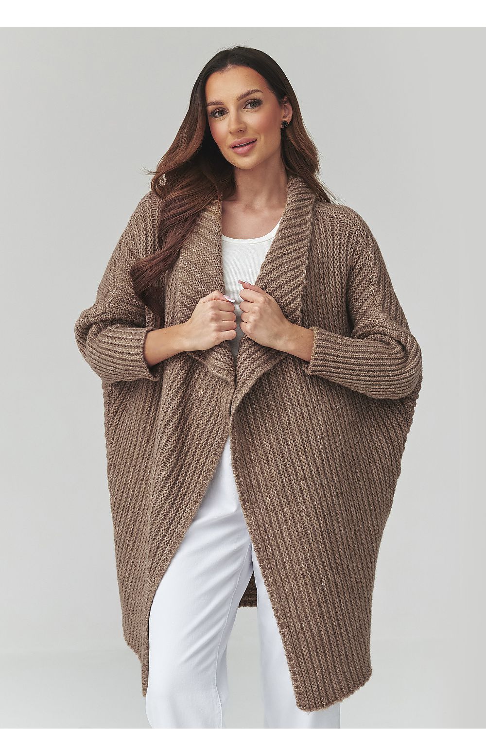 Woman wearing a brown knitted cardigan on a white background