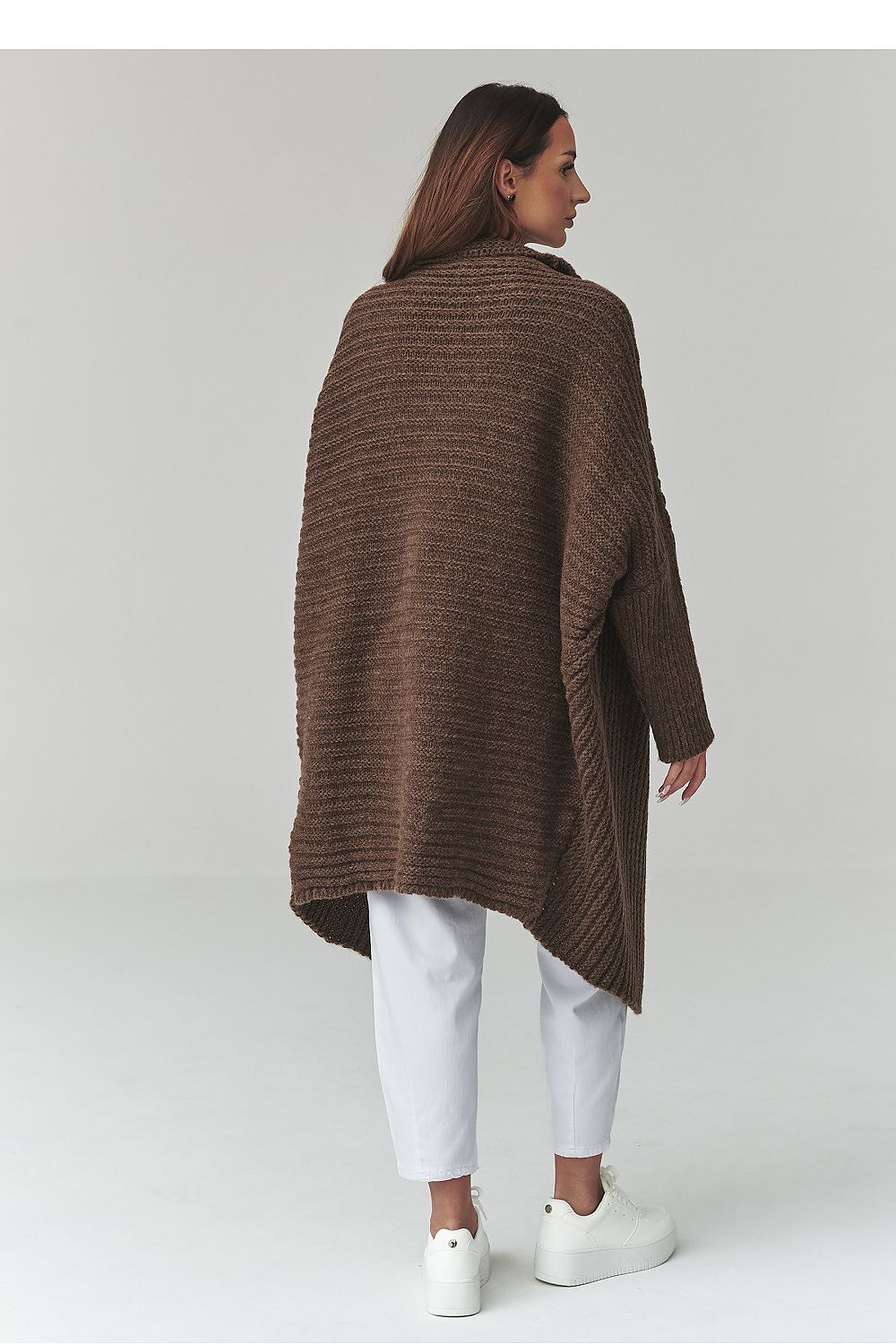 Woman wearing a brown textured coat on a white background
