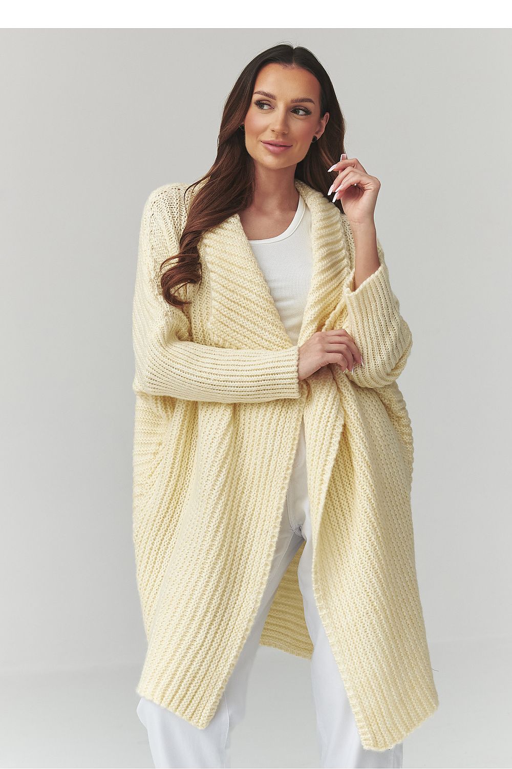 Women's longline oversized yellow knitted cardigan with textured knit design.