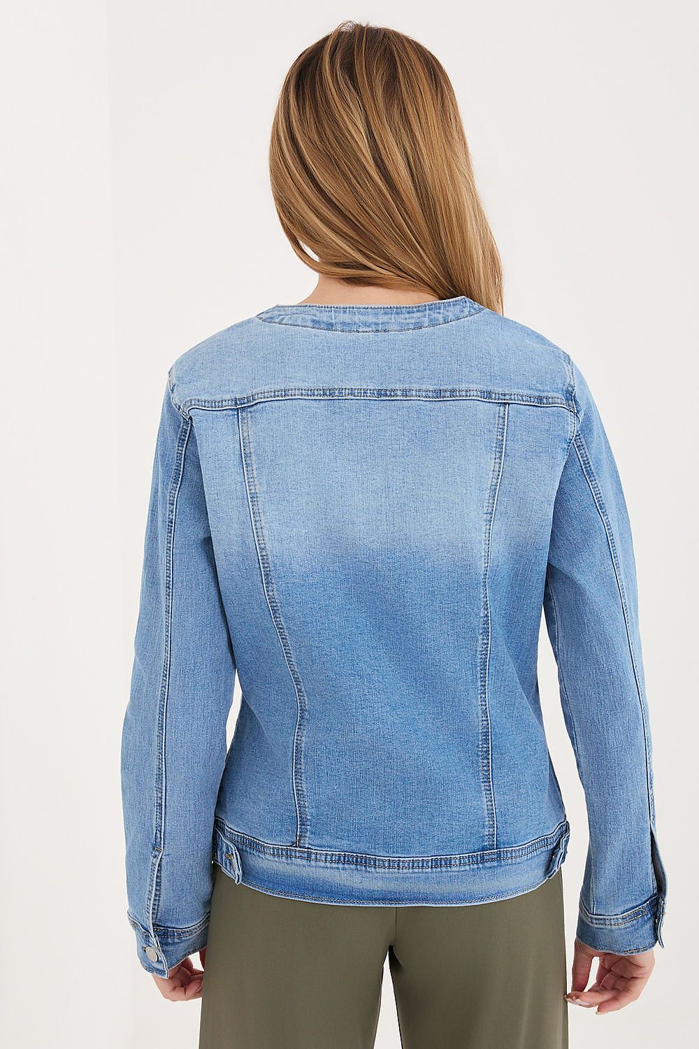 Blue denim jacket worn by a person on a white background