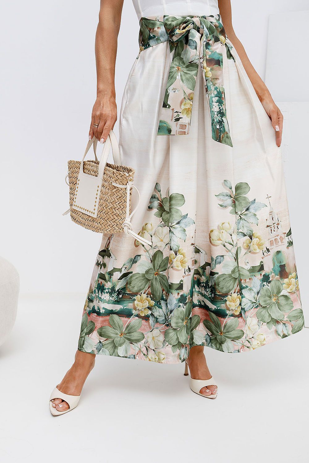 Person wearing a floral skirt with a white background