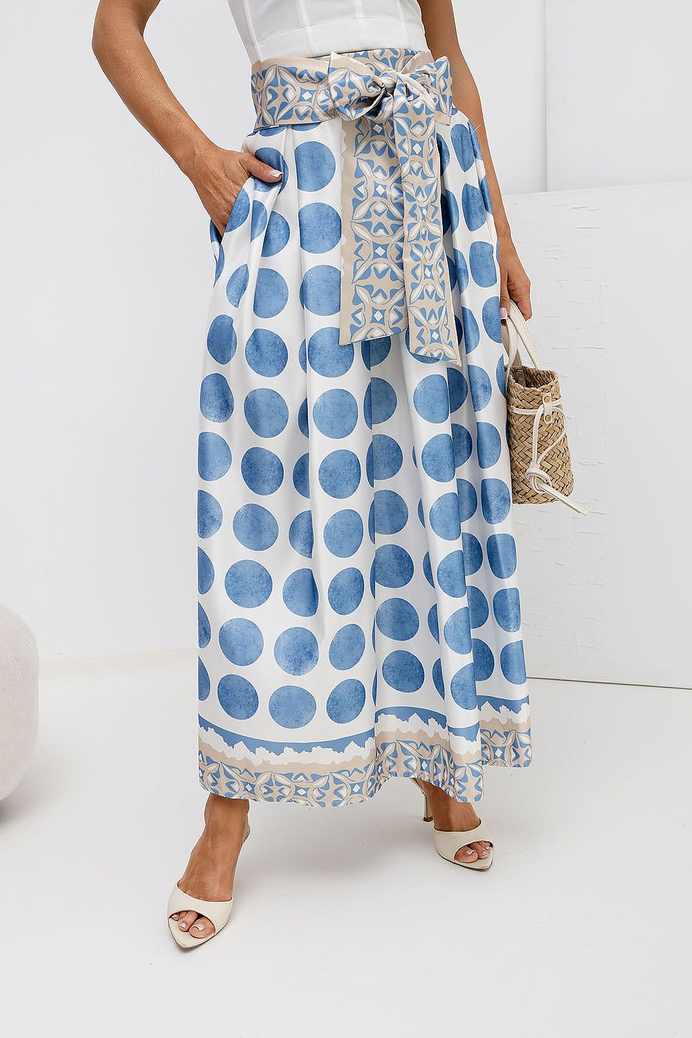 Person wearing a blue and white patterned skirt on a white background