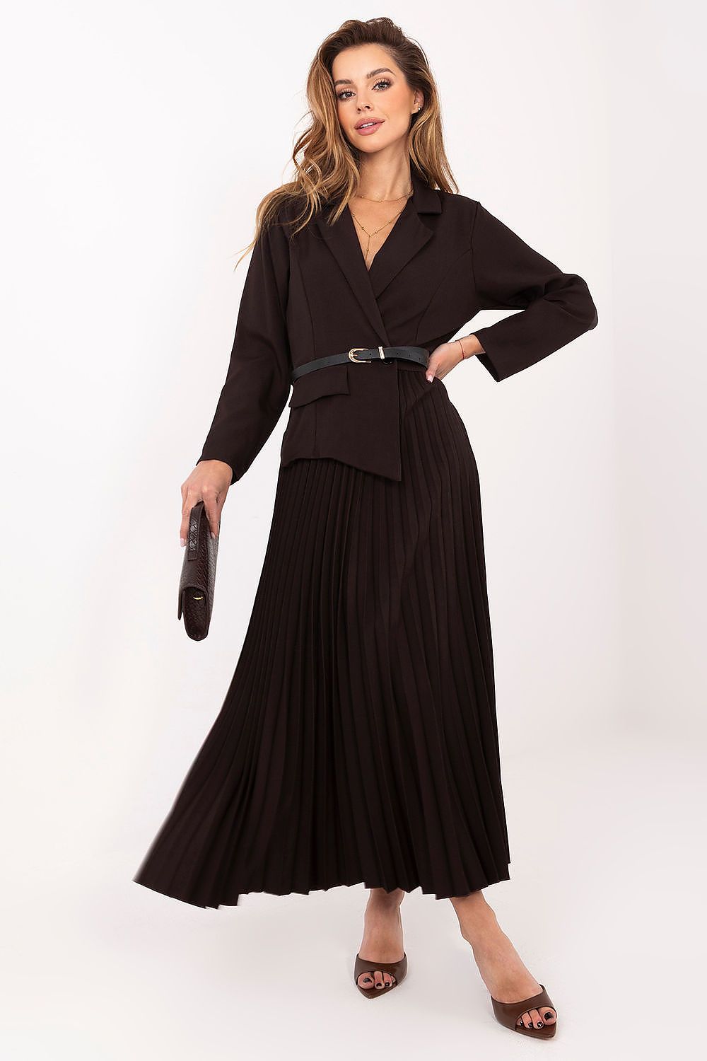 Woman wearing a black outfit with a belt on a white background