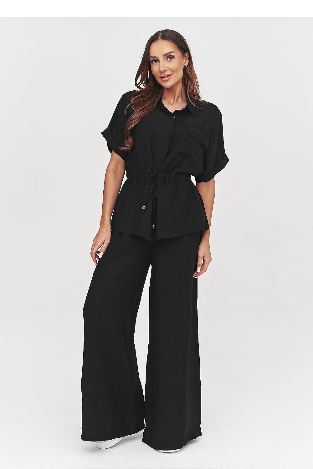 Woman wearing a black outfit on a white background