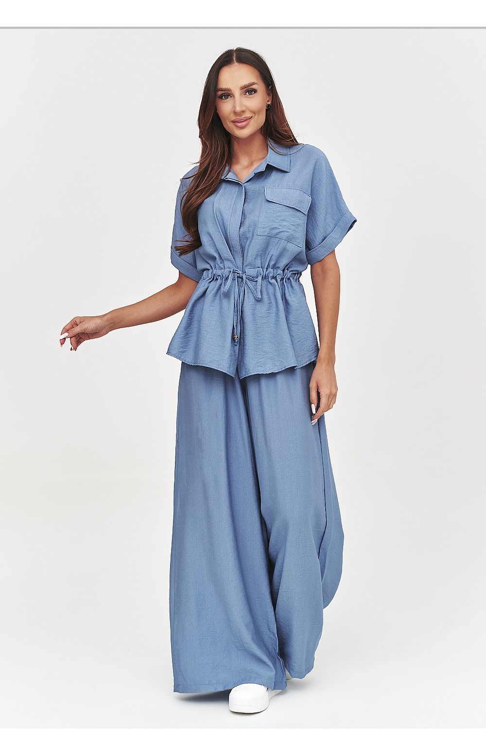 Woman wearing a blue denim outfit on a white background