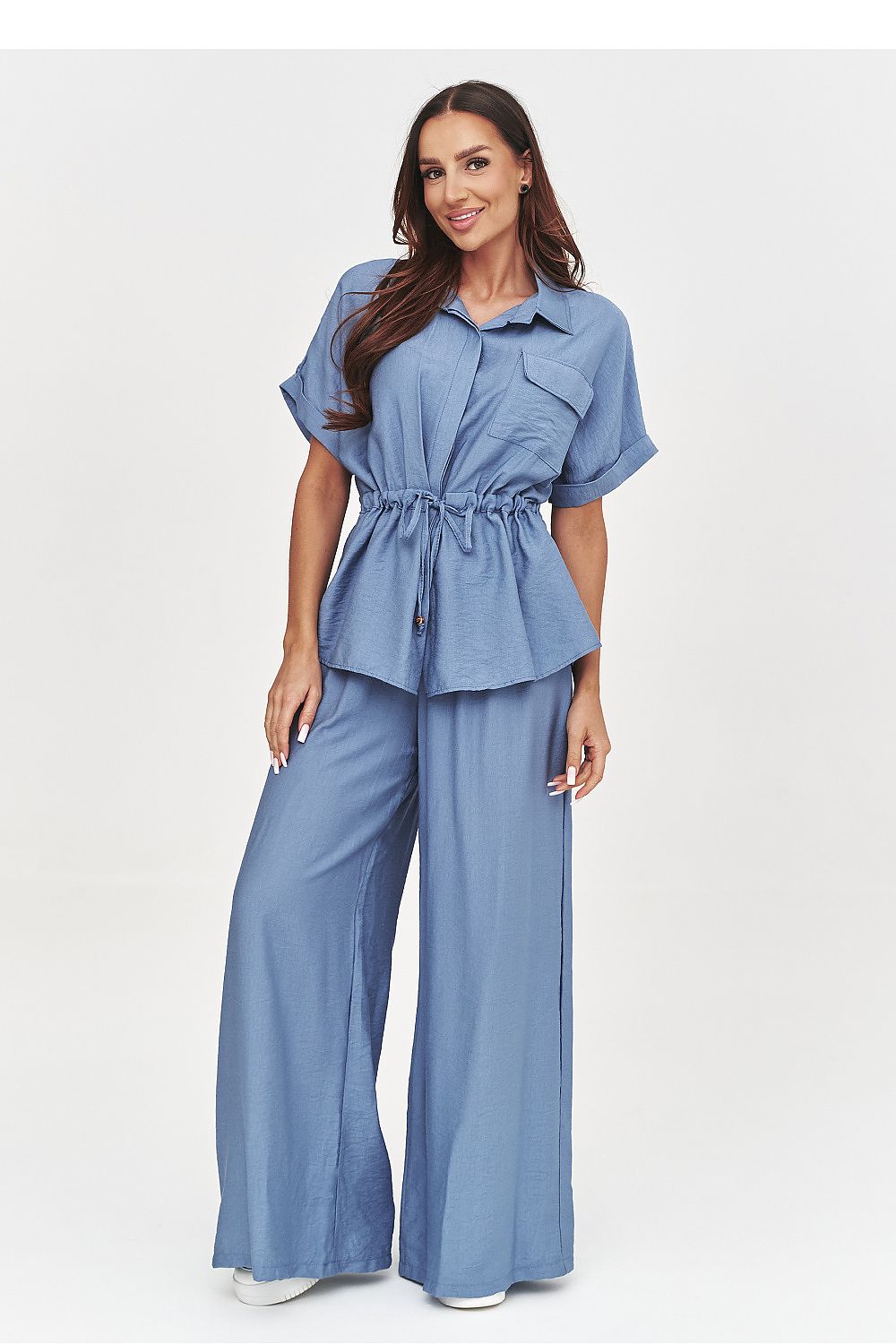 Woman wearing a blue denim outfit on a white background