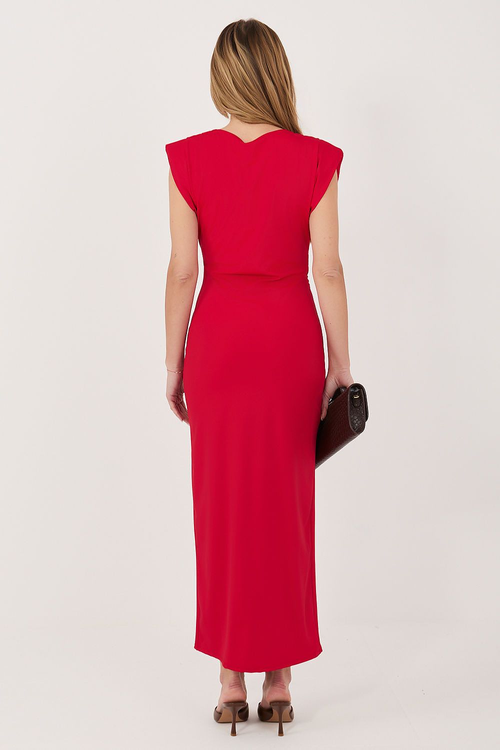 Woman wearing a red dress with a plain background