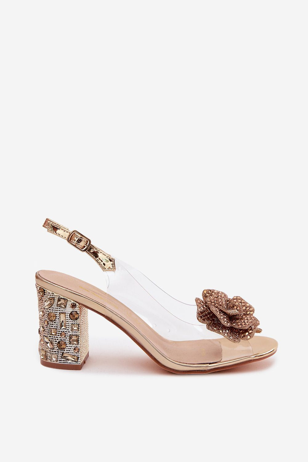 Elevated sandal with decorative block heel and clear strap on a white background