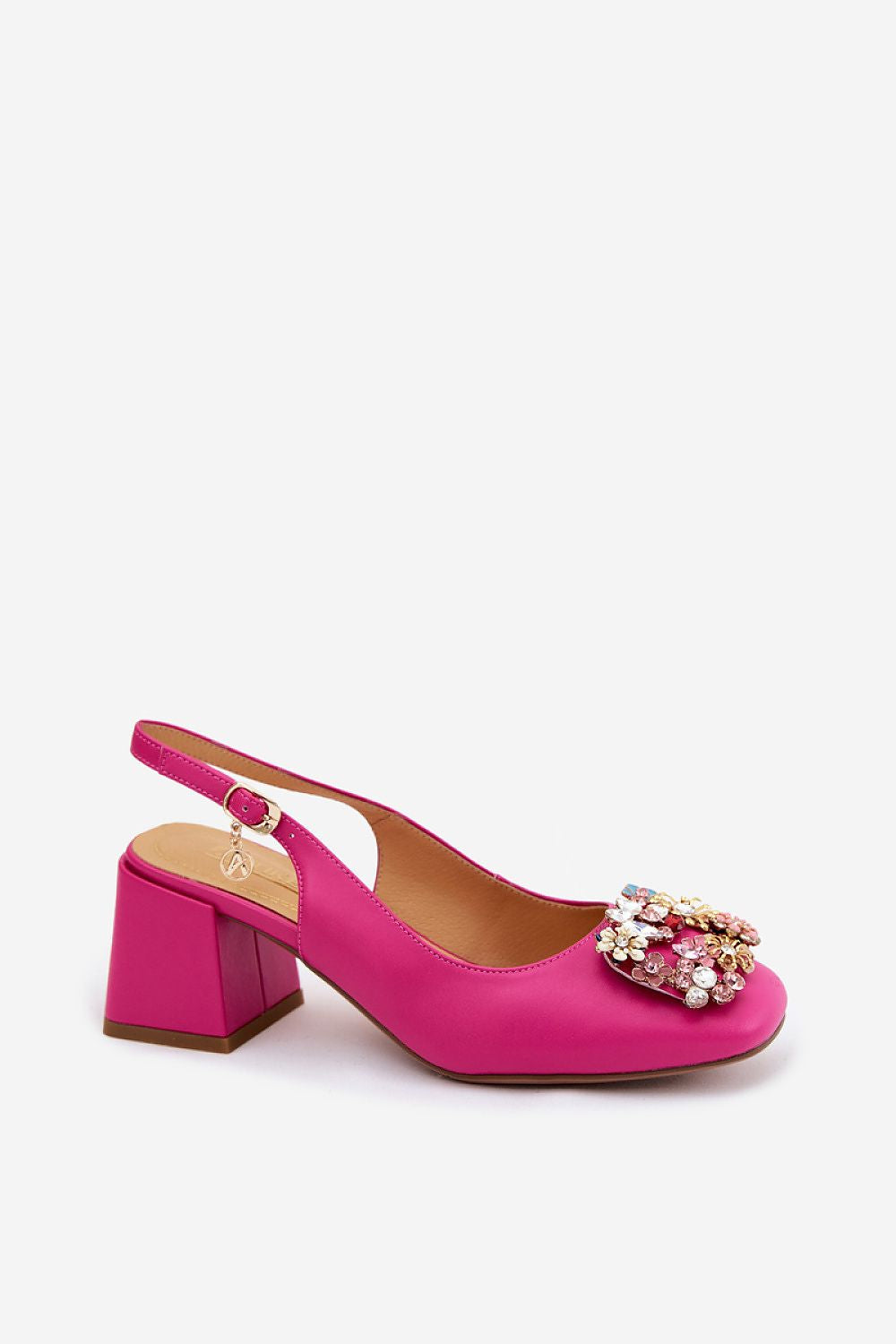 Pink high-heeled shoe with embellishments on a white background