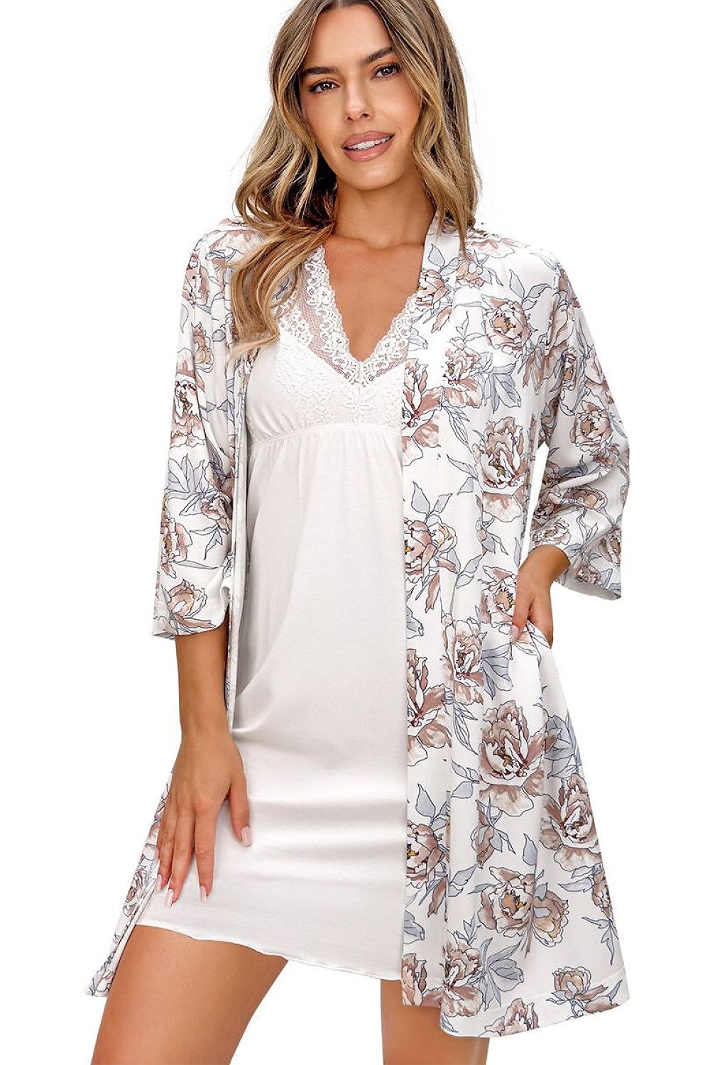 Woman wearing a floral robe over a white satin nightgown on a white background