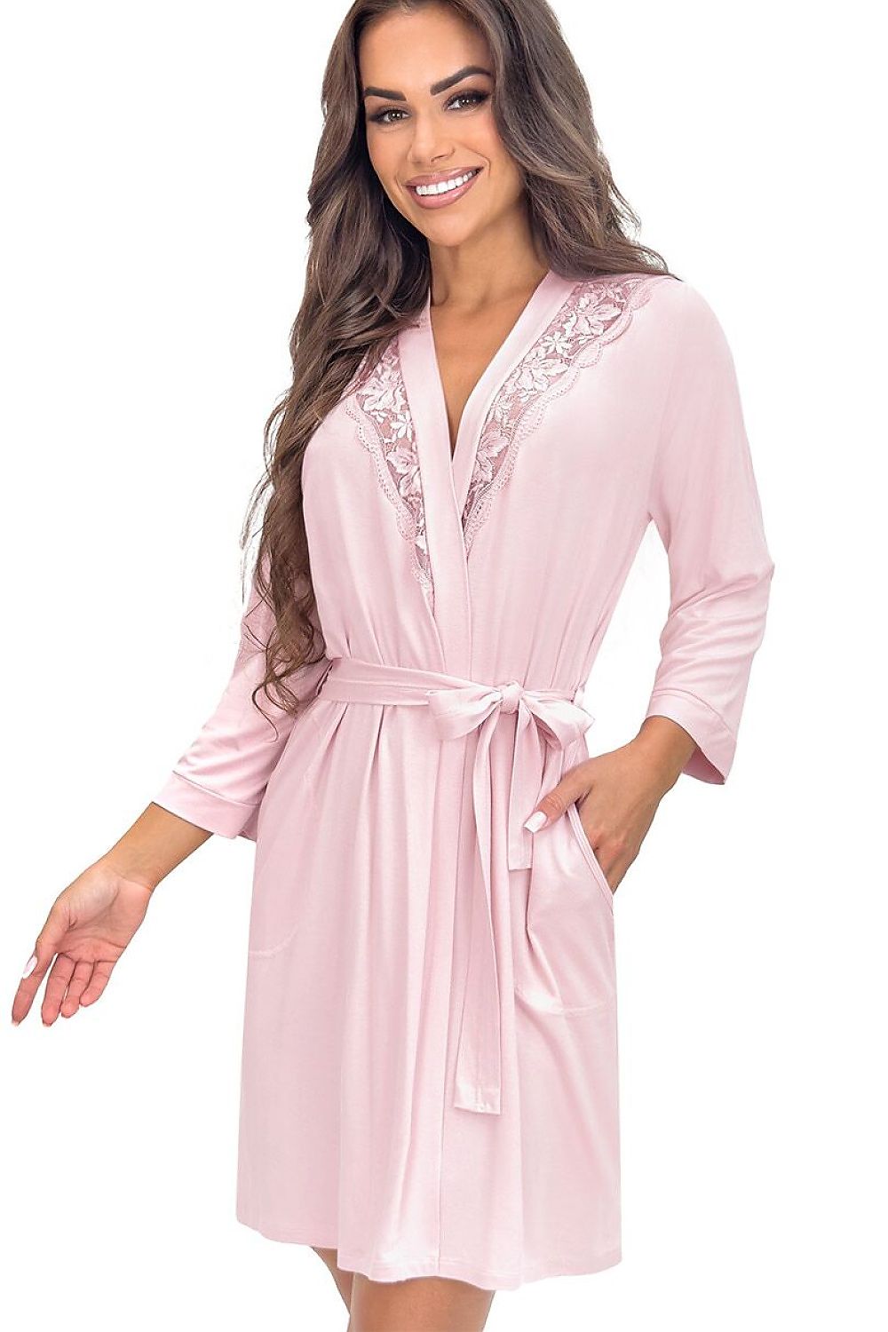 Woman wearing a pink satin robe with lace trim on a white background