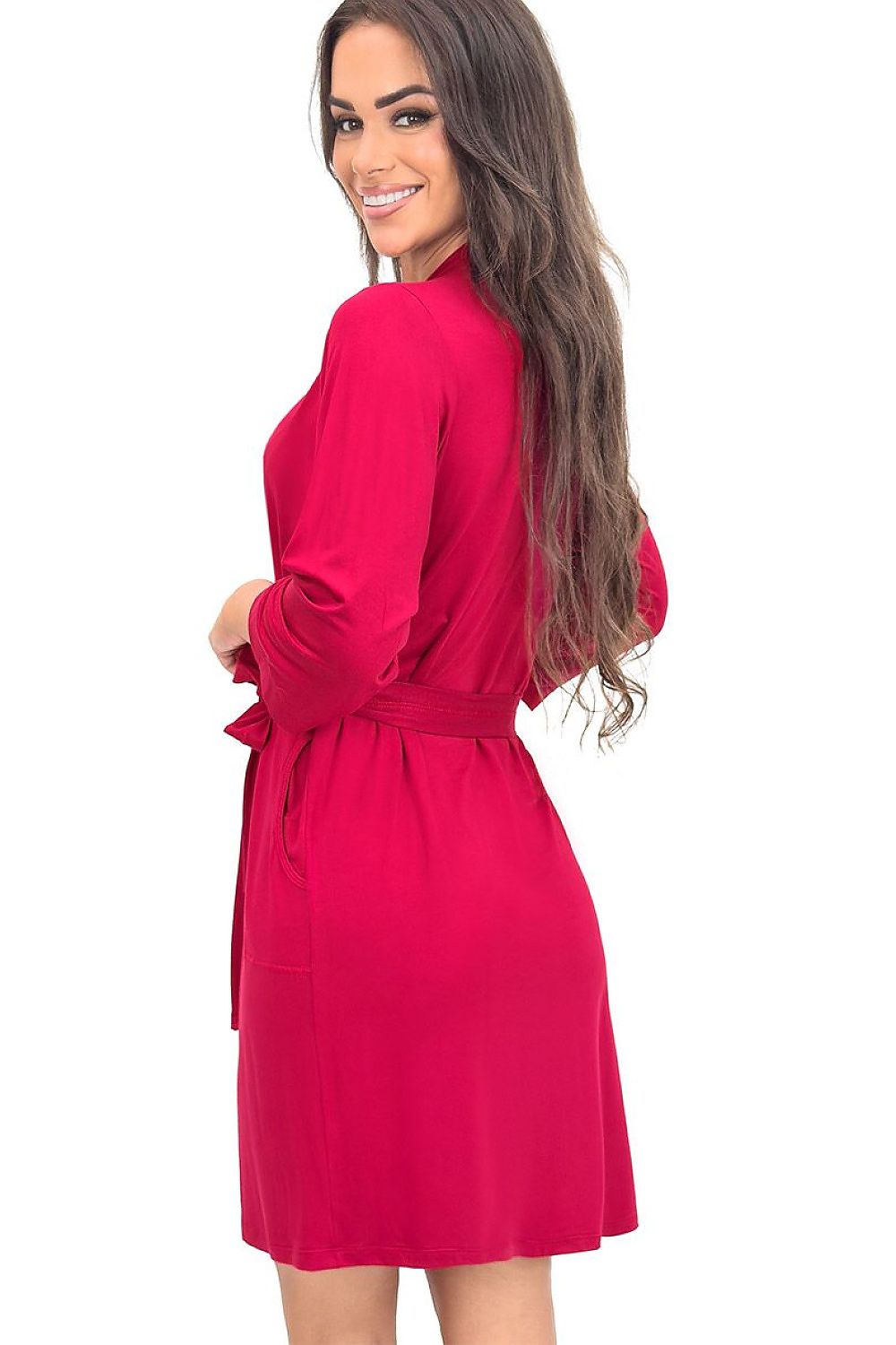 Woman wearing a bright pink dress with a belt on a white background