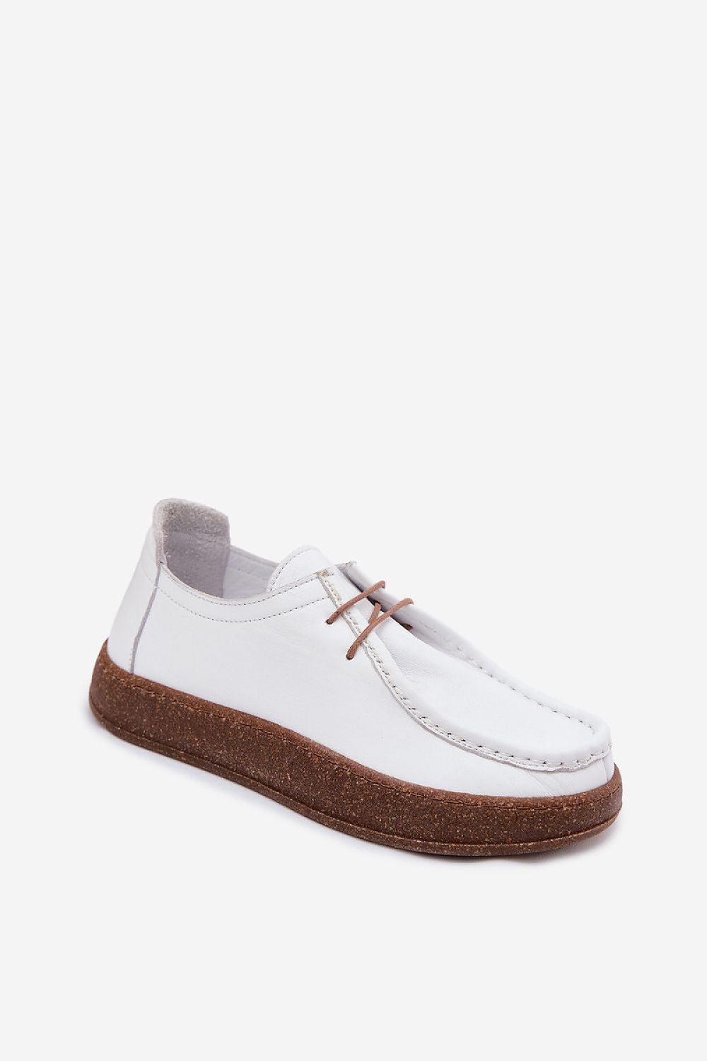 White shoe with brown sole on a white background