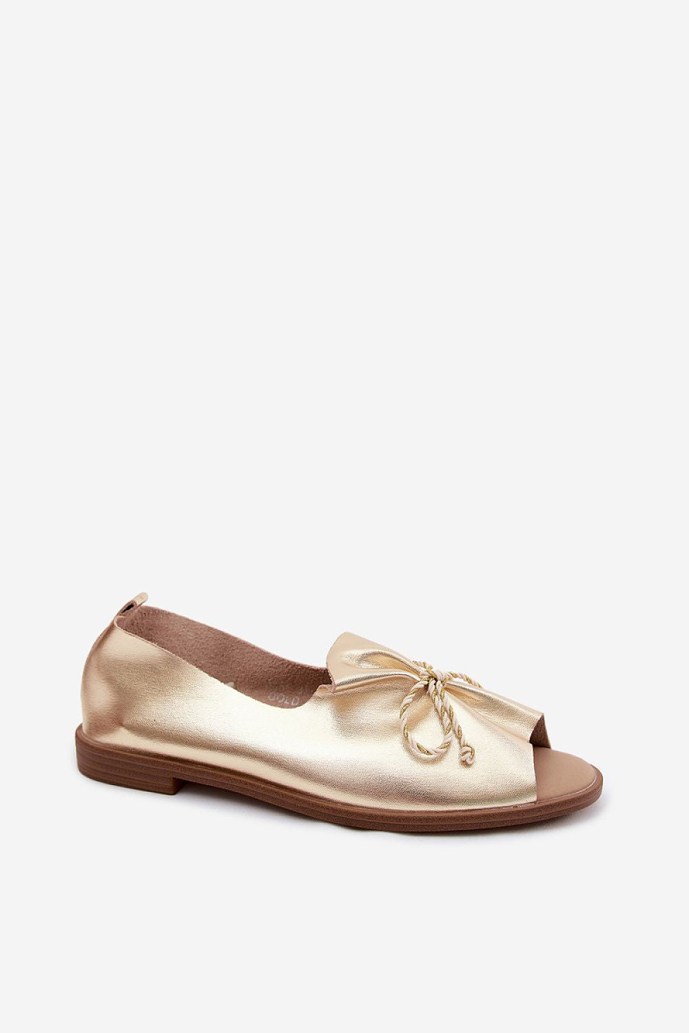 Gold flat shoe on a white background