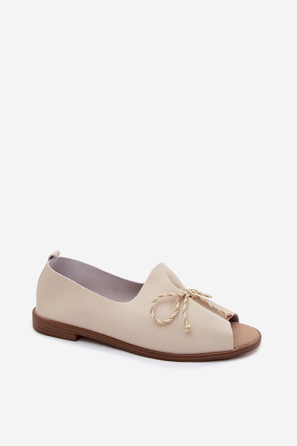 Beige flat shoe with a bow on a white background