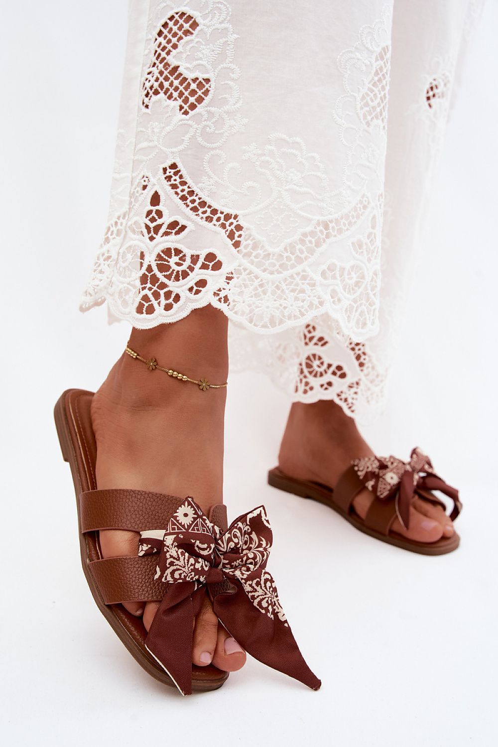  Brown flat sandals with statement bow detail and comfortable summer design
