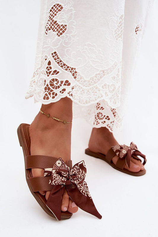  Brown flat sandals with statement bow detail and comfortable summer design