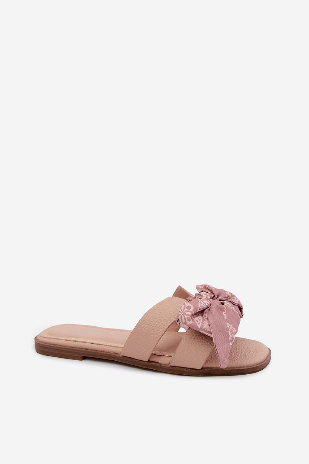 Pink sandal with a bow on a white background