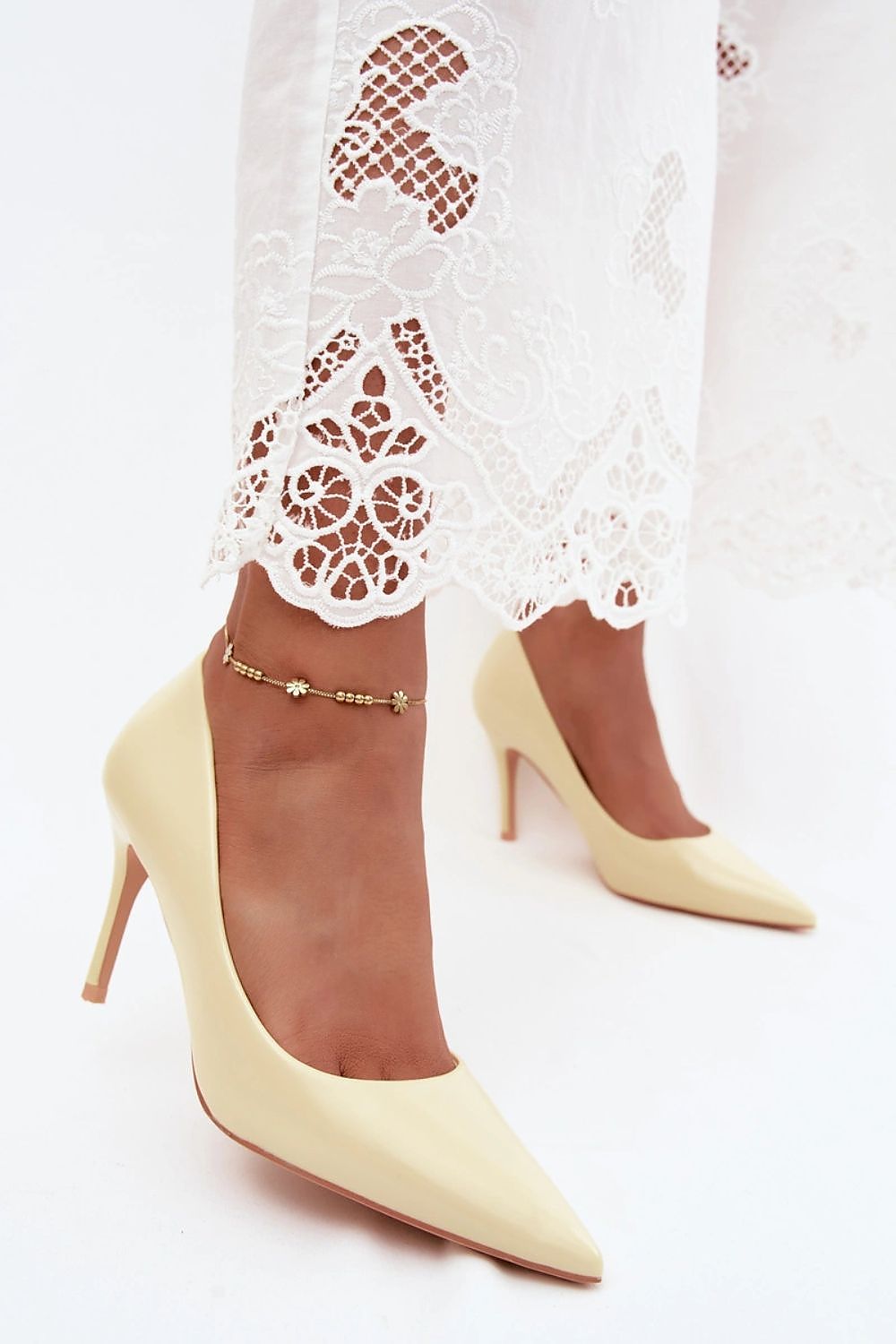Two high-heeled boots with brown and beige color scheme on a white background