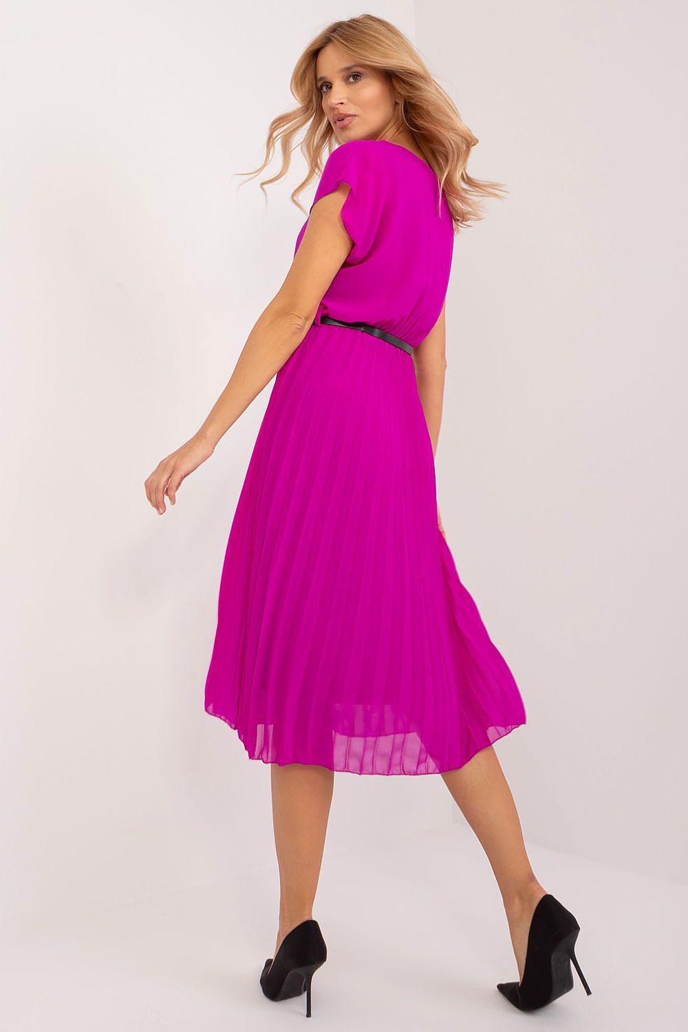 Woman wearing a bright pink dress on a white background