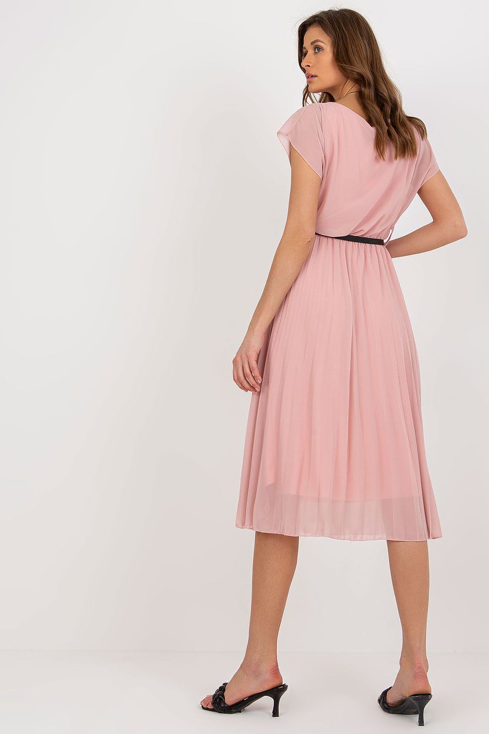 Woman wearing a pink dress on a white background