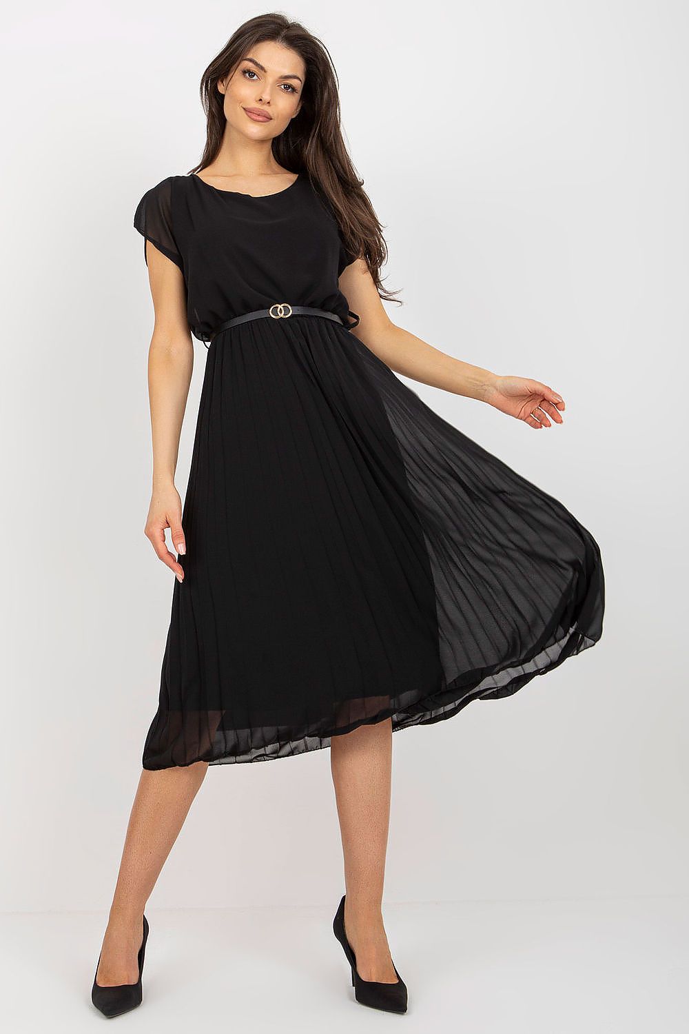 Woman wearing a black dress with a belt on a white background