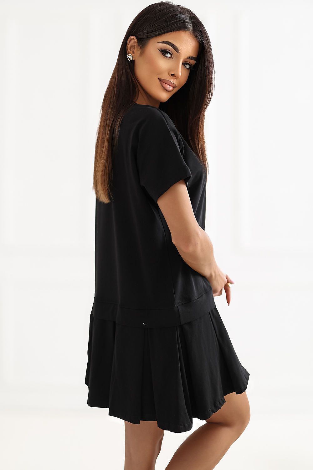 Woman wearing a black dress on a white background