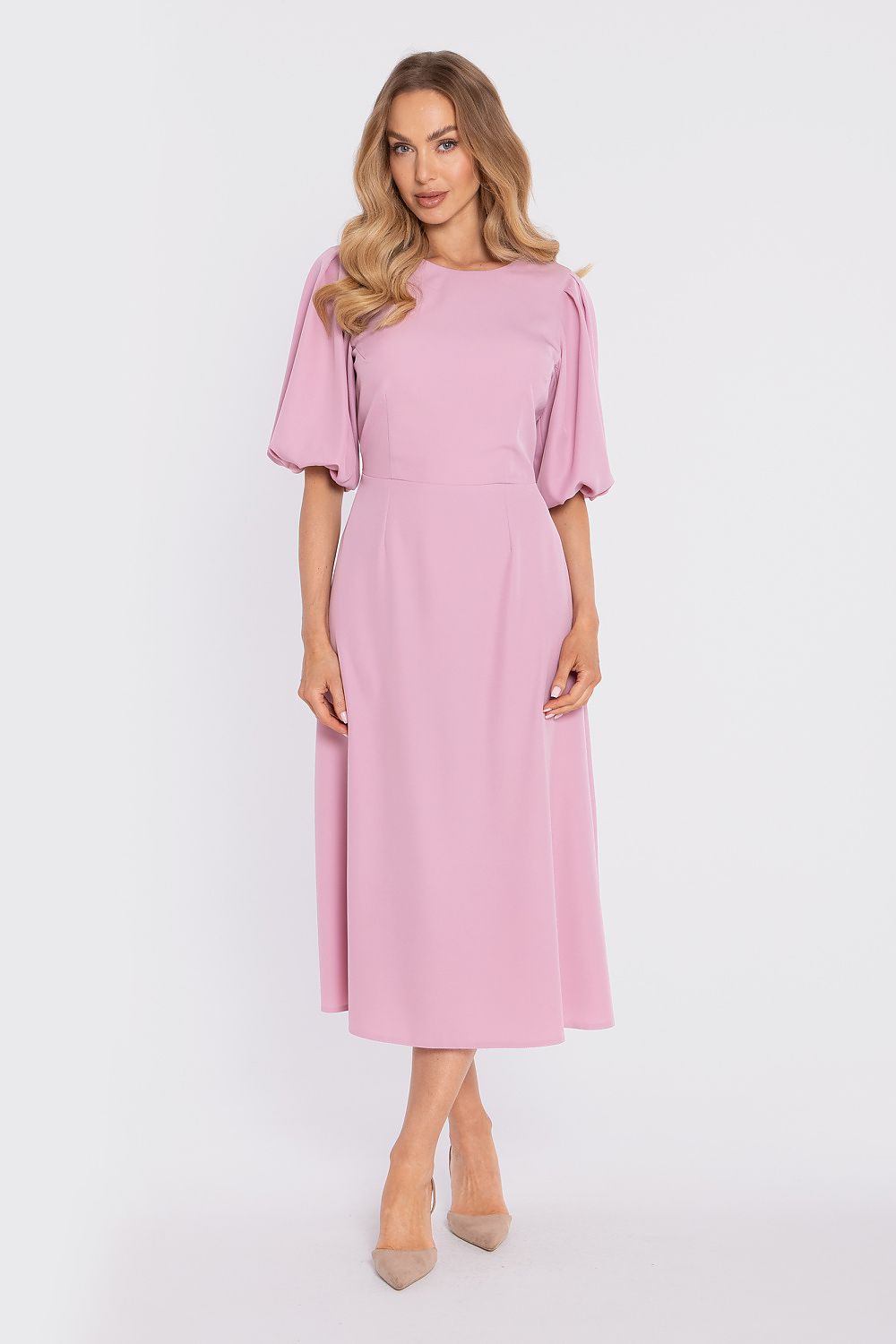Woman wearing a pink dress on a white background