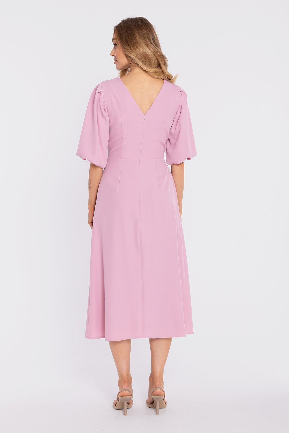 Woman wearing a pink dress on a white background