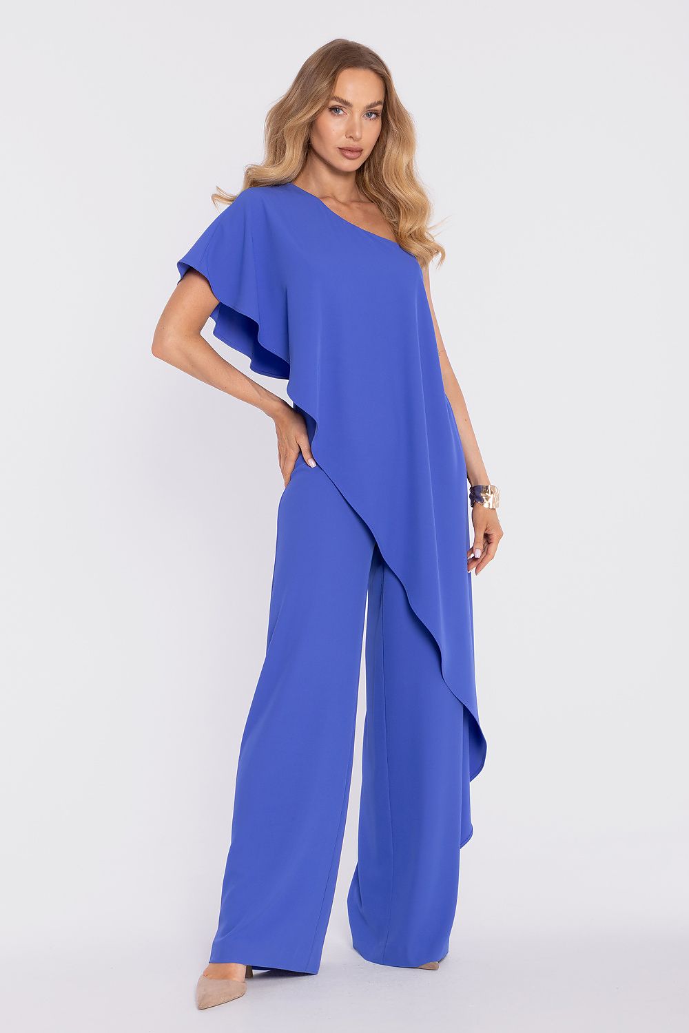 Woman wearing a blue jumpsuit on a white background