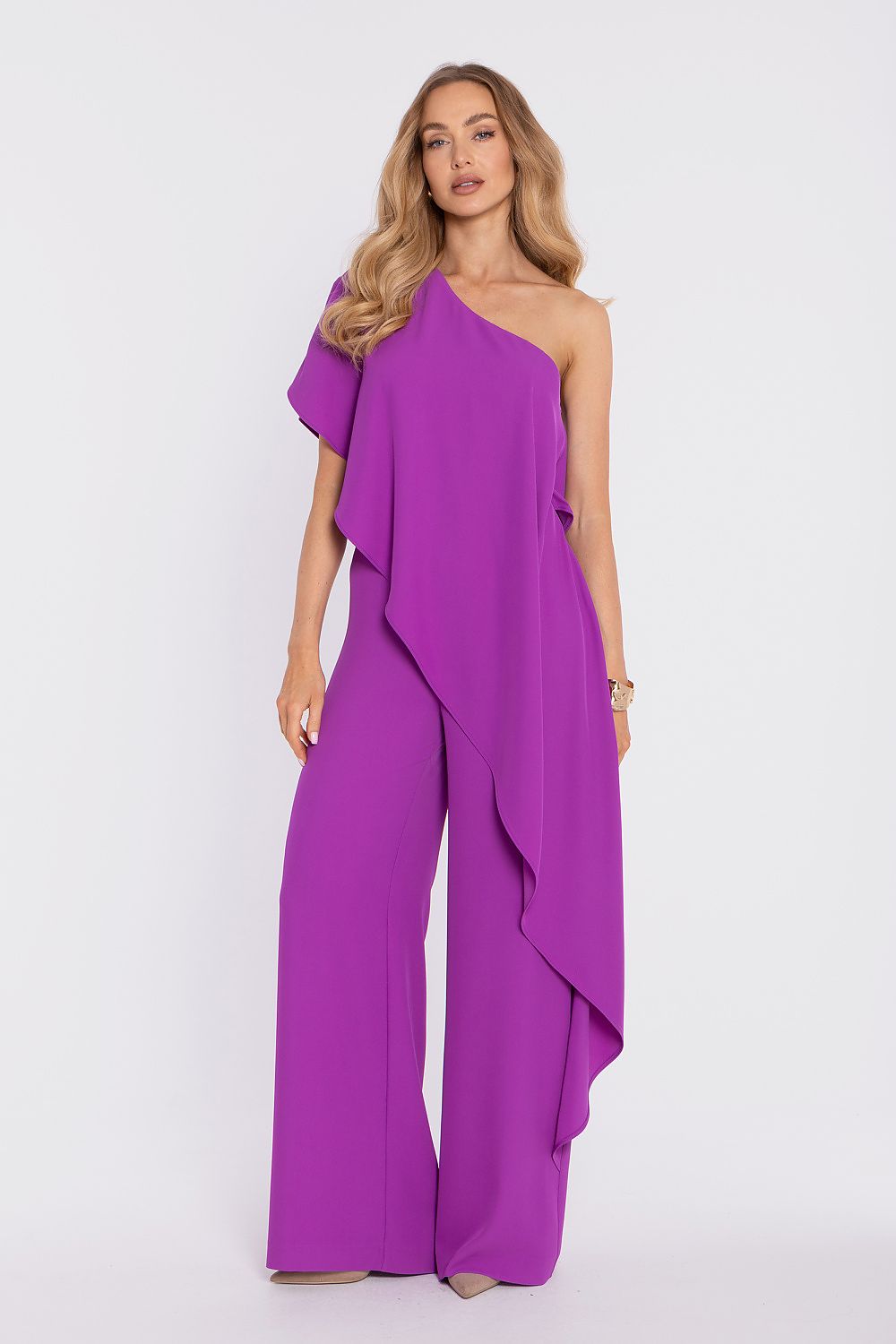 Woman wearing a purple one-shoulder jumpsuit on a white background