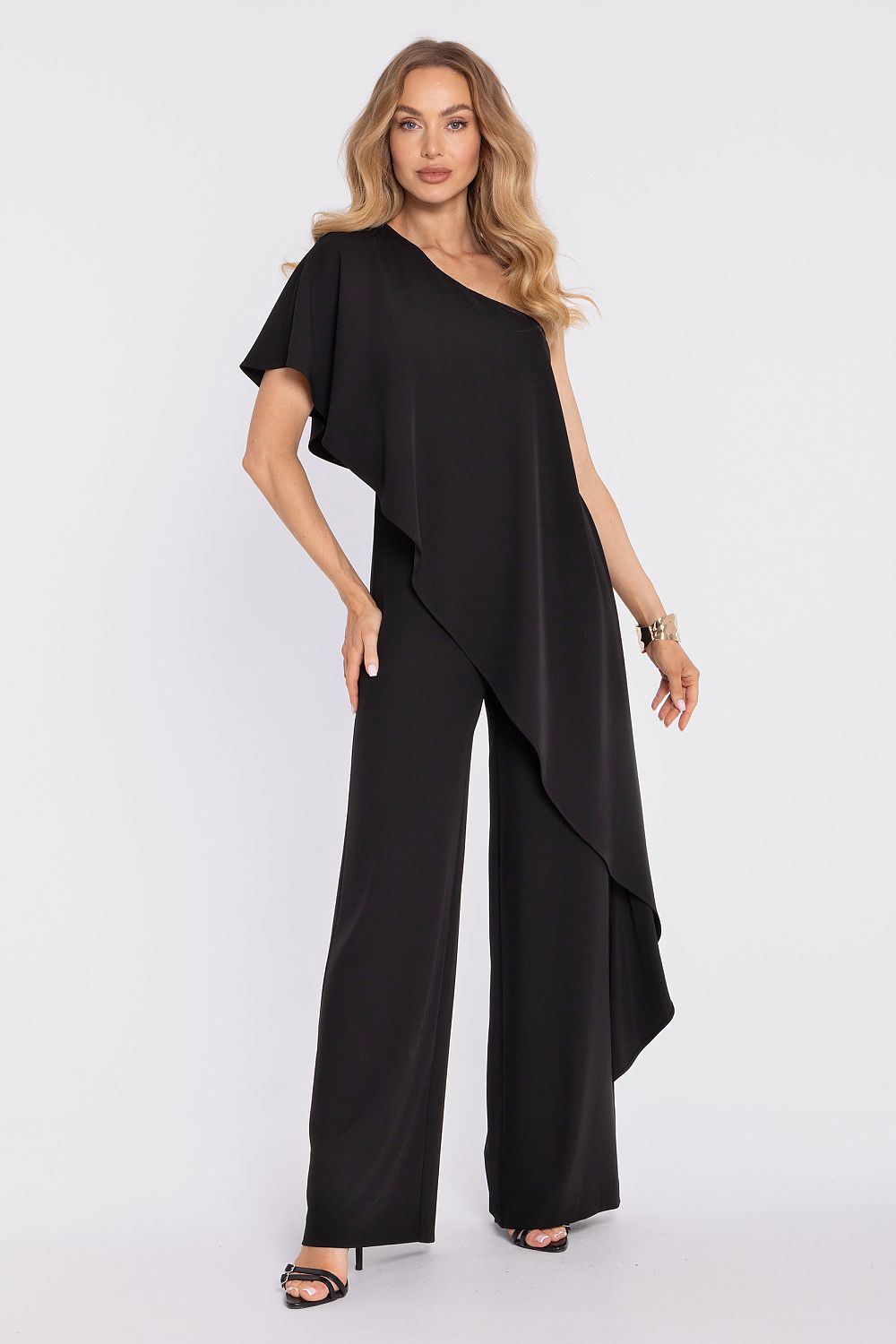 Woman wearing a black jumpsuit on a white background