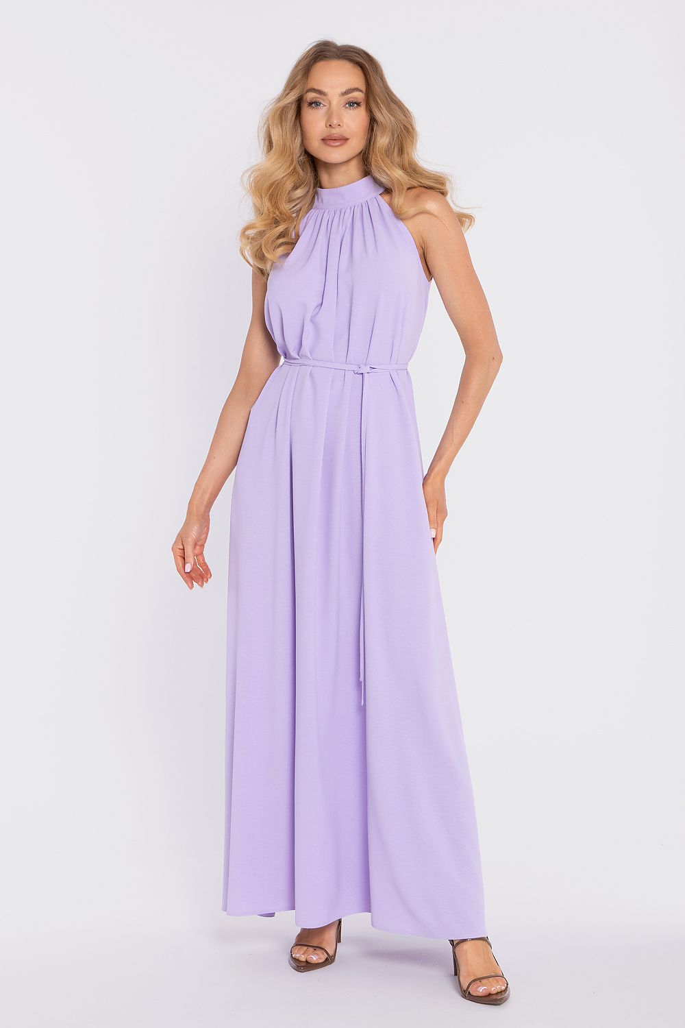 Woman wearing a long lavender dress on a white background