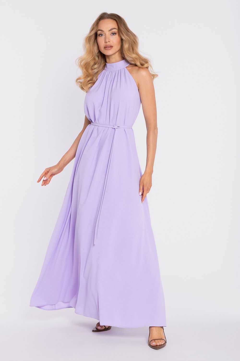 Woman wearing a lavender dress against a white background